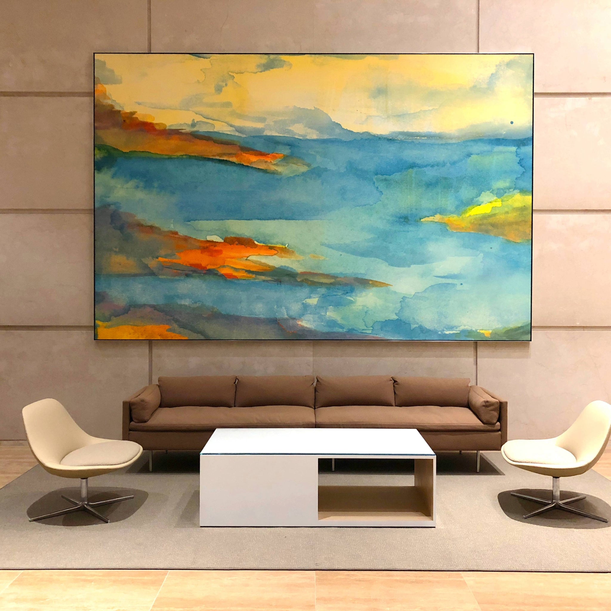 Lobby of 100 Spectrum featuring a serene large abstract painting by WRAPPED Studio, with bold blue and yellow tones evoking a sense of calm in the corporate environment.