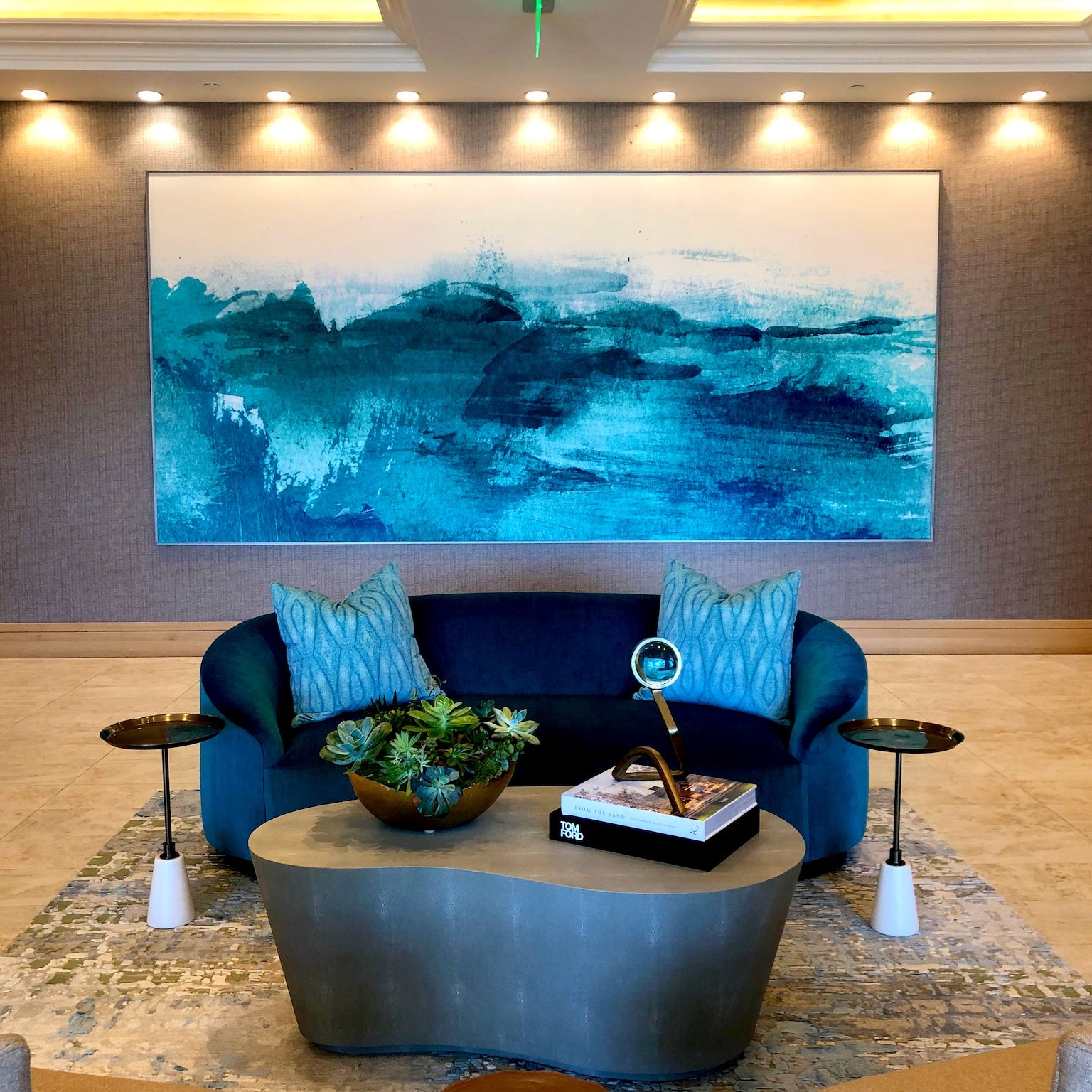 Upscale reception area at 1221 Avenue enhanced by WRAPPED Studio's custom oceanic artwork, capturing the serene energy of the sea with its vivid blue color palette.