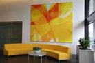 610 Newport Center's lobby showcases WRAPPED Studio's abstract art in yellow and red tones, infusing the corporate space with sophistication and warmth.