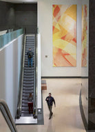 Interior of 71 South Wacker Drive lobby featuring a large-scale abstract canvas with dynamic yellow and red strokes by WRAPPED Studio, highlighting the building's modern aesthetic.