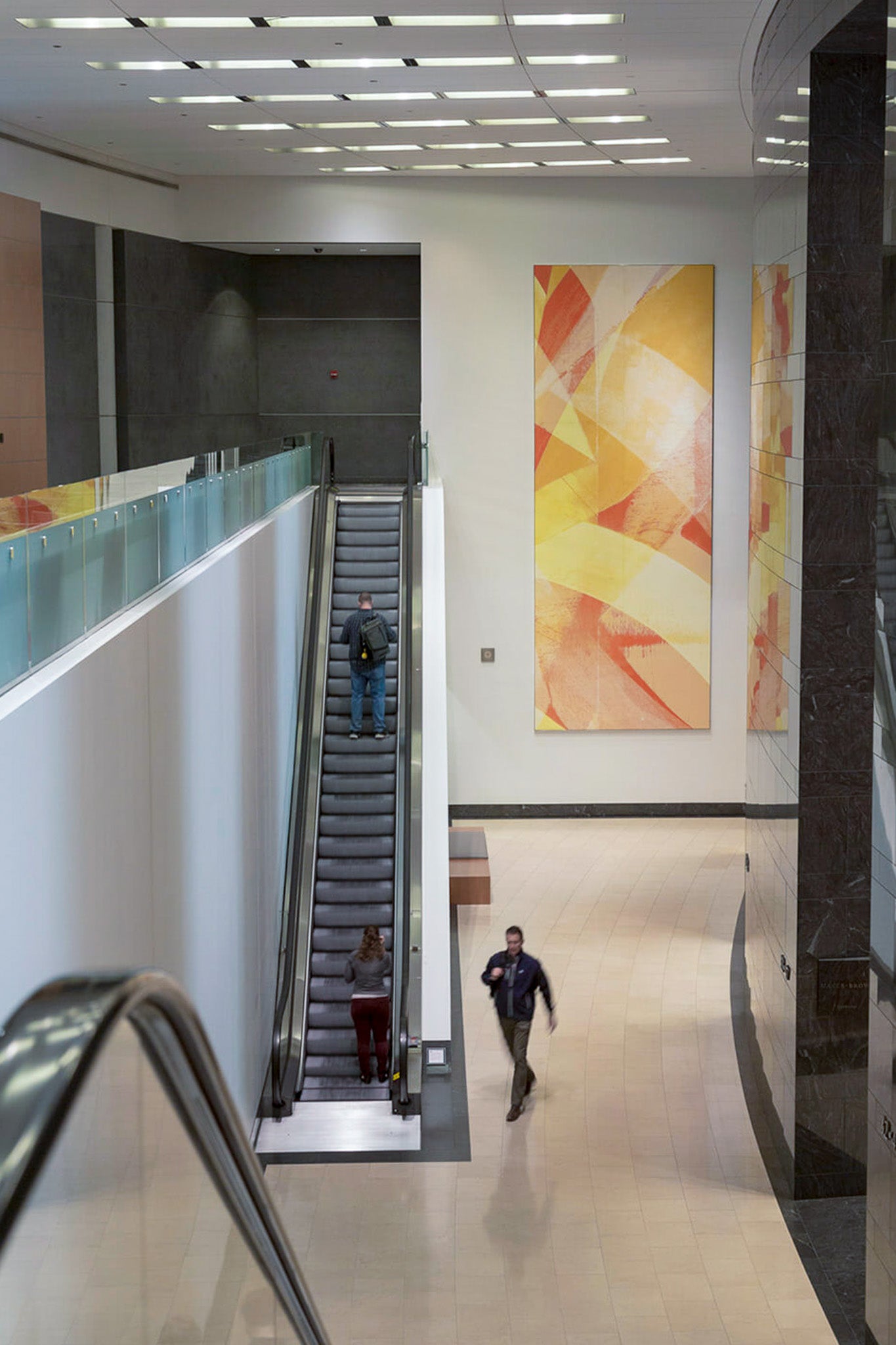 Interior of 71 South Wacker Drive lobby featuring a large-scale abstract canvas with dynamic yellow and red strokes by WRAPPED Studio, highlighting the building's modern aesthetic.