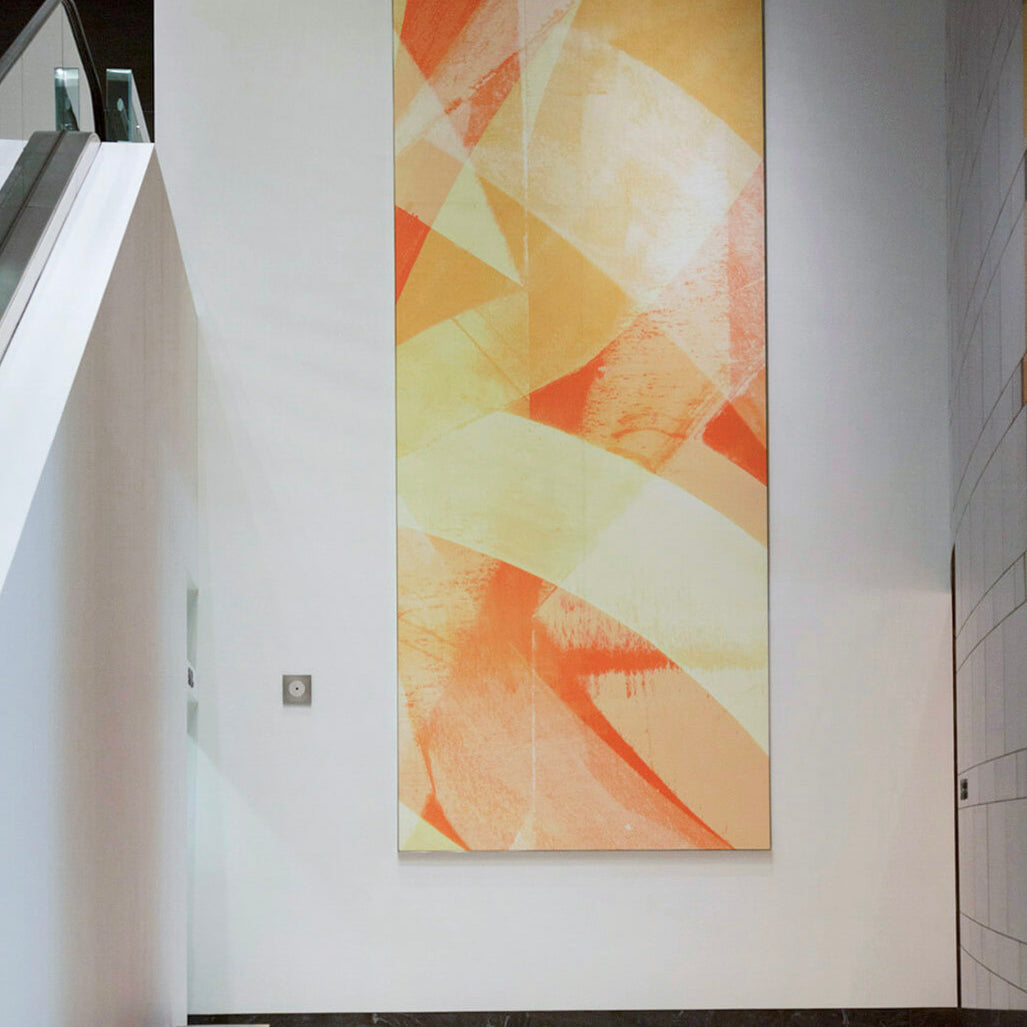 Abstract artwork  with dynamic yellow and red strokes by WRAPPED Studio installed in the lobby of 71 South Wacker Drive.