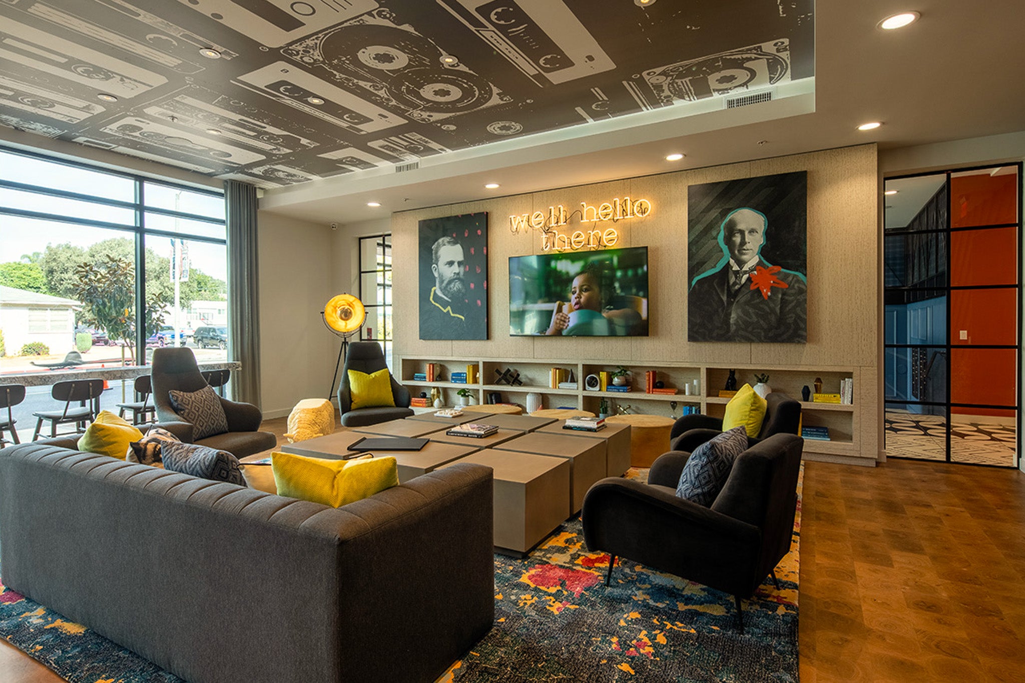 WRAPPED Studio art installation with cassette tape ceiling mural and two graphic portraits, created for Amplifi in Fullerton.
