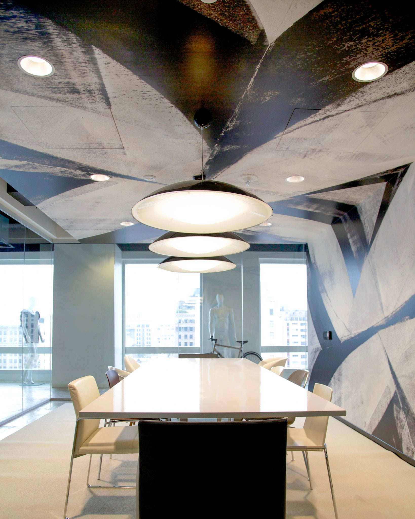 Brookfield Design Hive's productivity suite showcasing WRAPPED Studio's Frank Stella-inspired black-and-white wallcovering and stylish circular lighting.