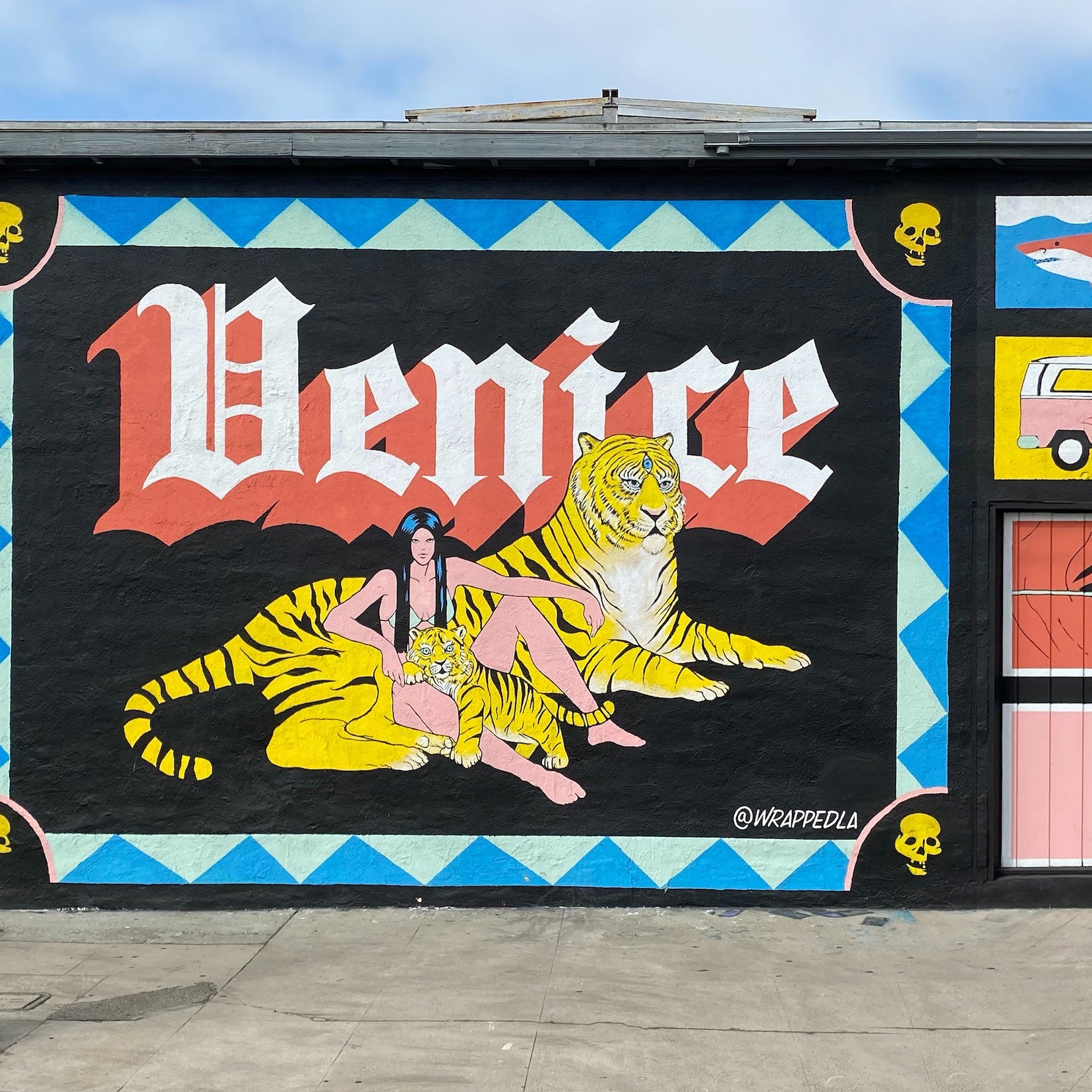 A segment of the Venice mural showcasing the 'Venice' lettering with a lifelike tiger and figure, reflecting the community's rich and diverse artistic heritage.