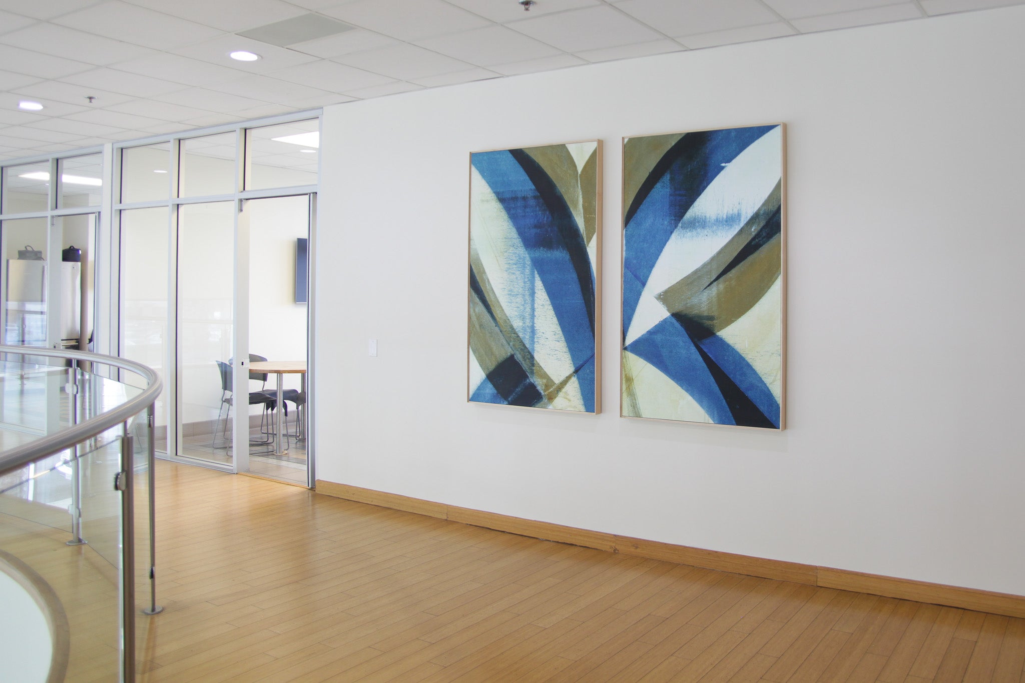 Blue and gold abstract diptych by WRAPPED Studio, designed to reflect brand colors and elevate the interior of a modern automotive dealership.