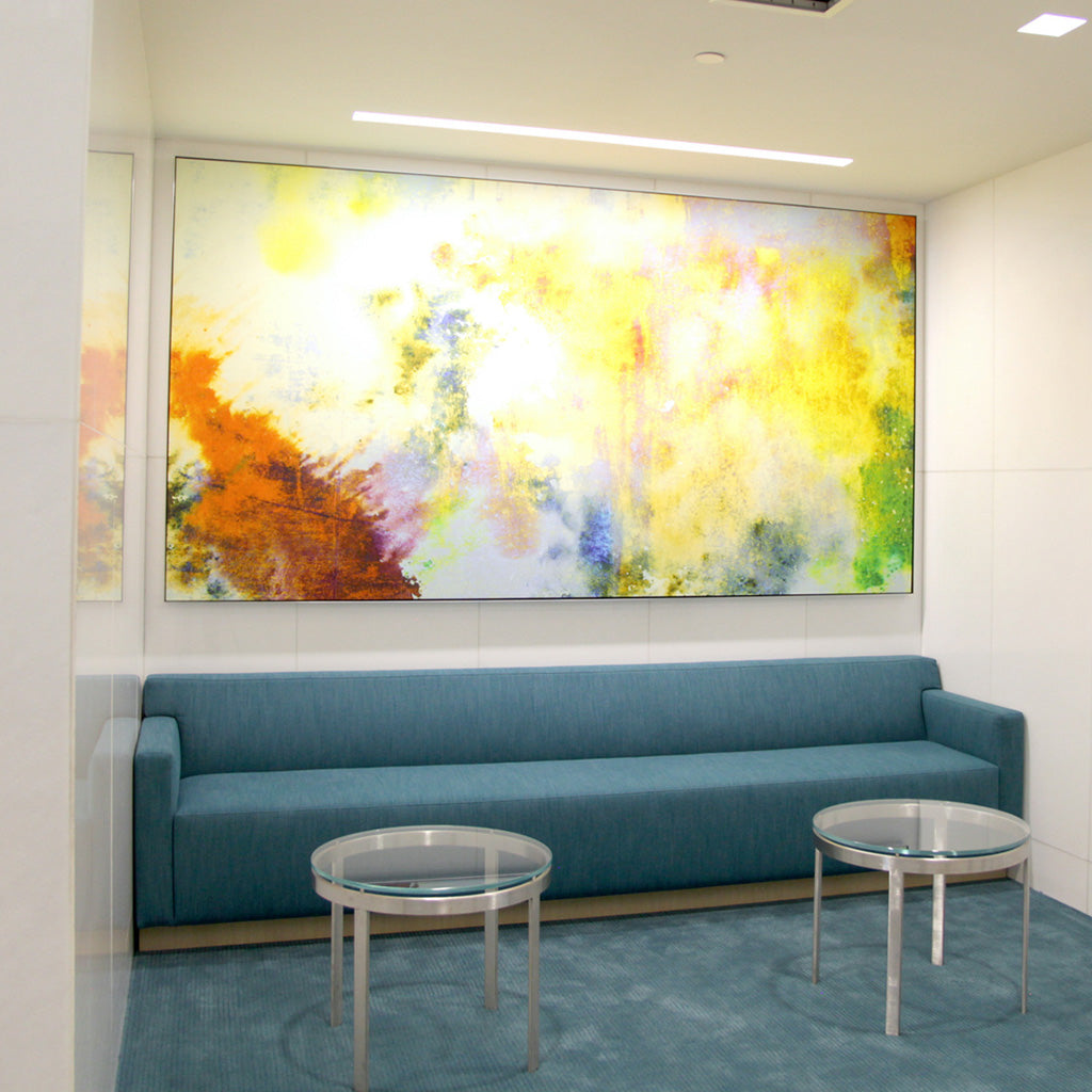 Warm yellow and orange abstract canvas art by WRAPPED Studio in Jamboree Center's offices.