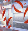 Video art thumbnail depicting stylized glass arcs in shades of red and gold, set against a cloudy sky background, creating a feeling of movement and curvature.