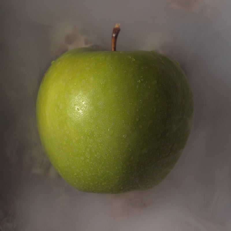 A crisp, green apple enveloped in a hazy mist, creating a surreal and tantalizing visual, serves as the thumbnail for a video art project that plays with perception and reality.