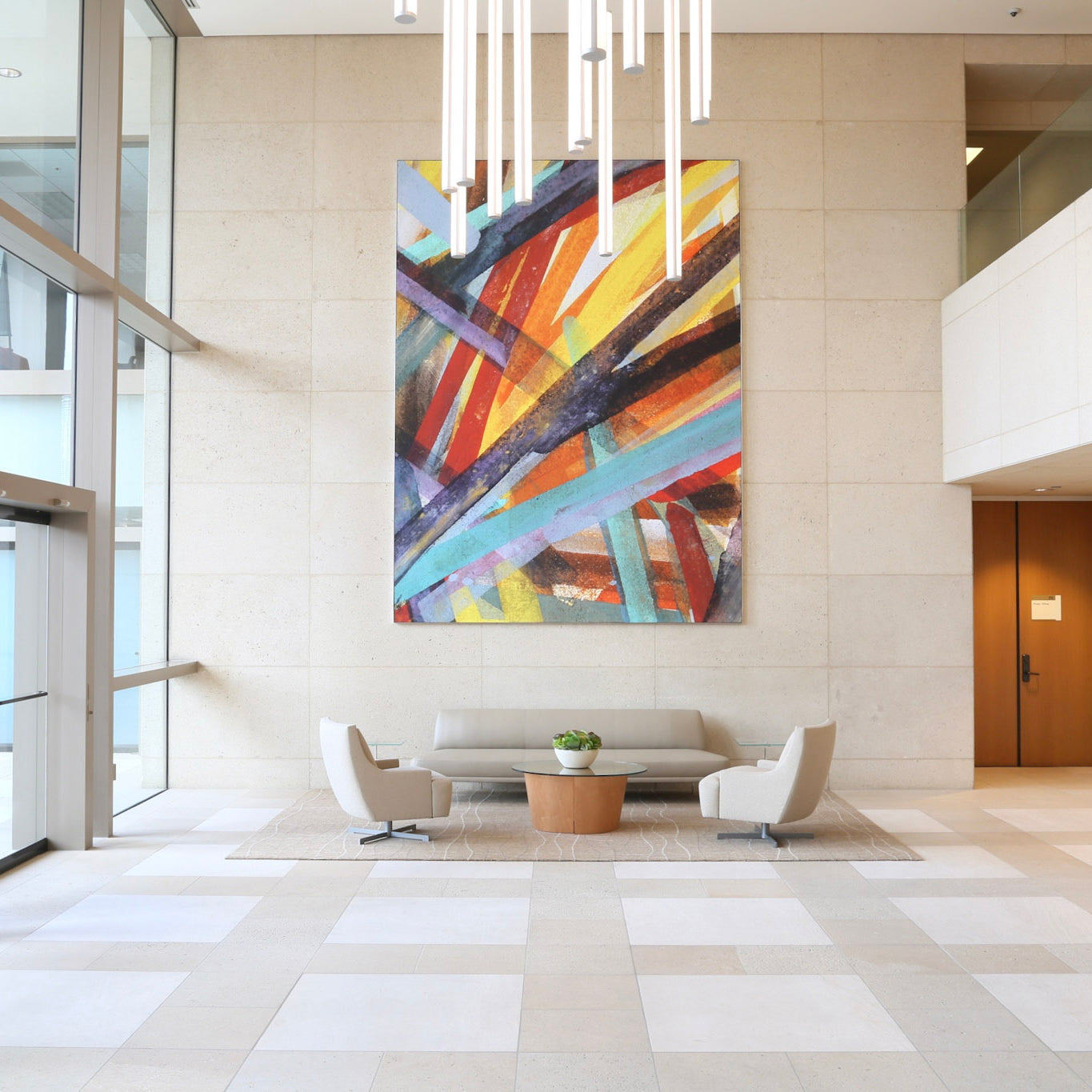 Large abstract painting with dynamic diagonal lines in warm and cool tones, enhancing the contemporary lobby at 300 Spectrum Center by WRAPPED Studio.