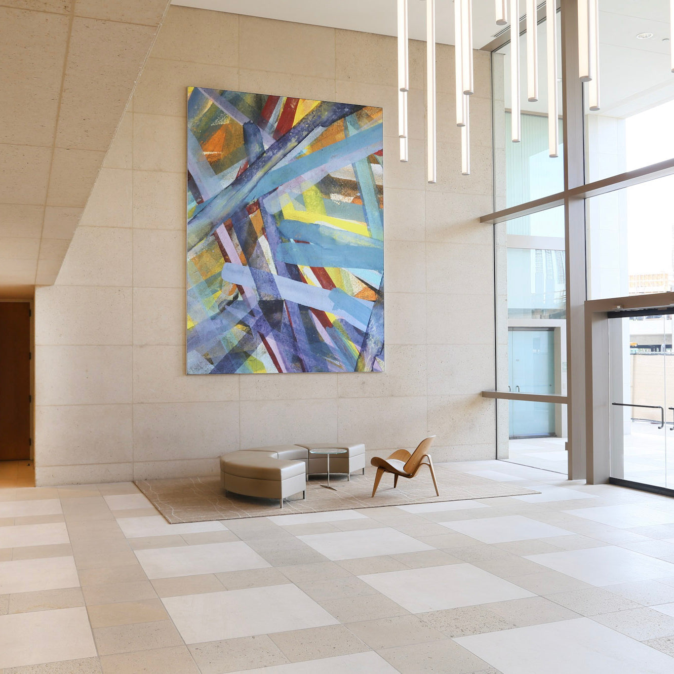 Abstract canvas with interlacing blue and purple strokes on display at the 300 Spectrum Center, reflecting WRAPPED Studio's vibrant office lobby art.
