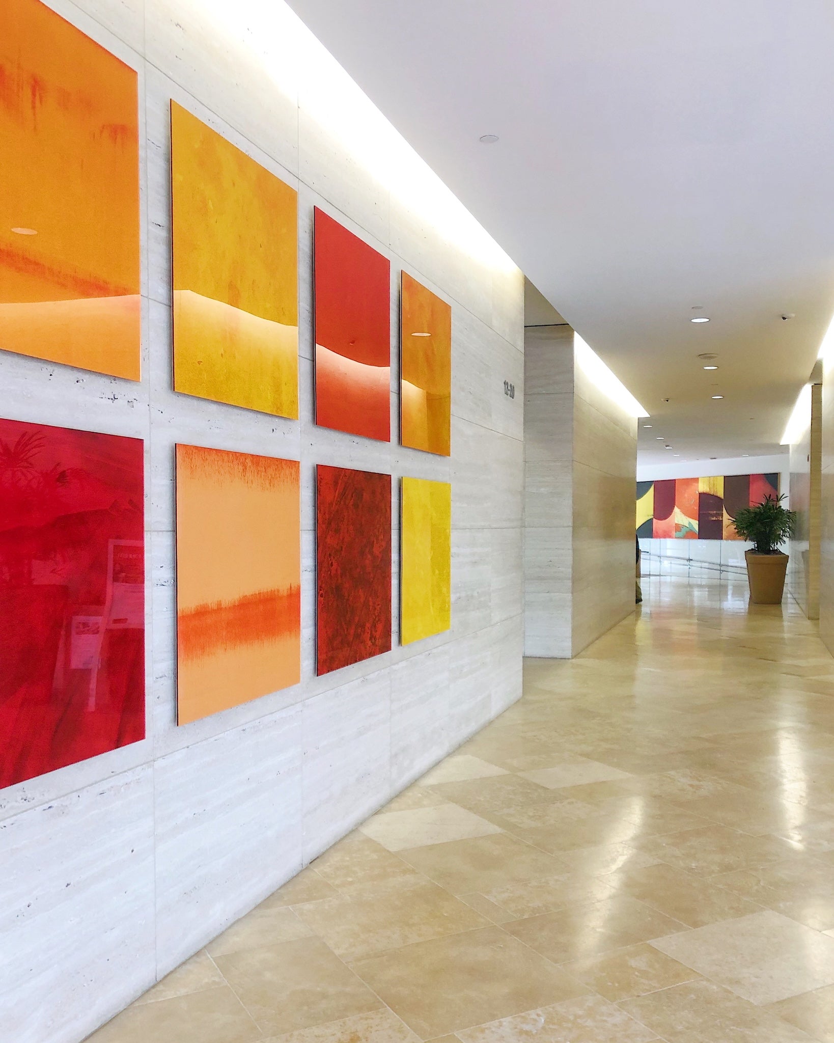Vibrant abstract acrylic panel artwork installed along a corporate corridor at 101 Broadway, designed by WRAPPED Studio.