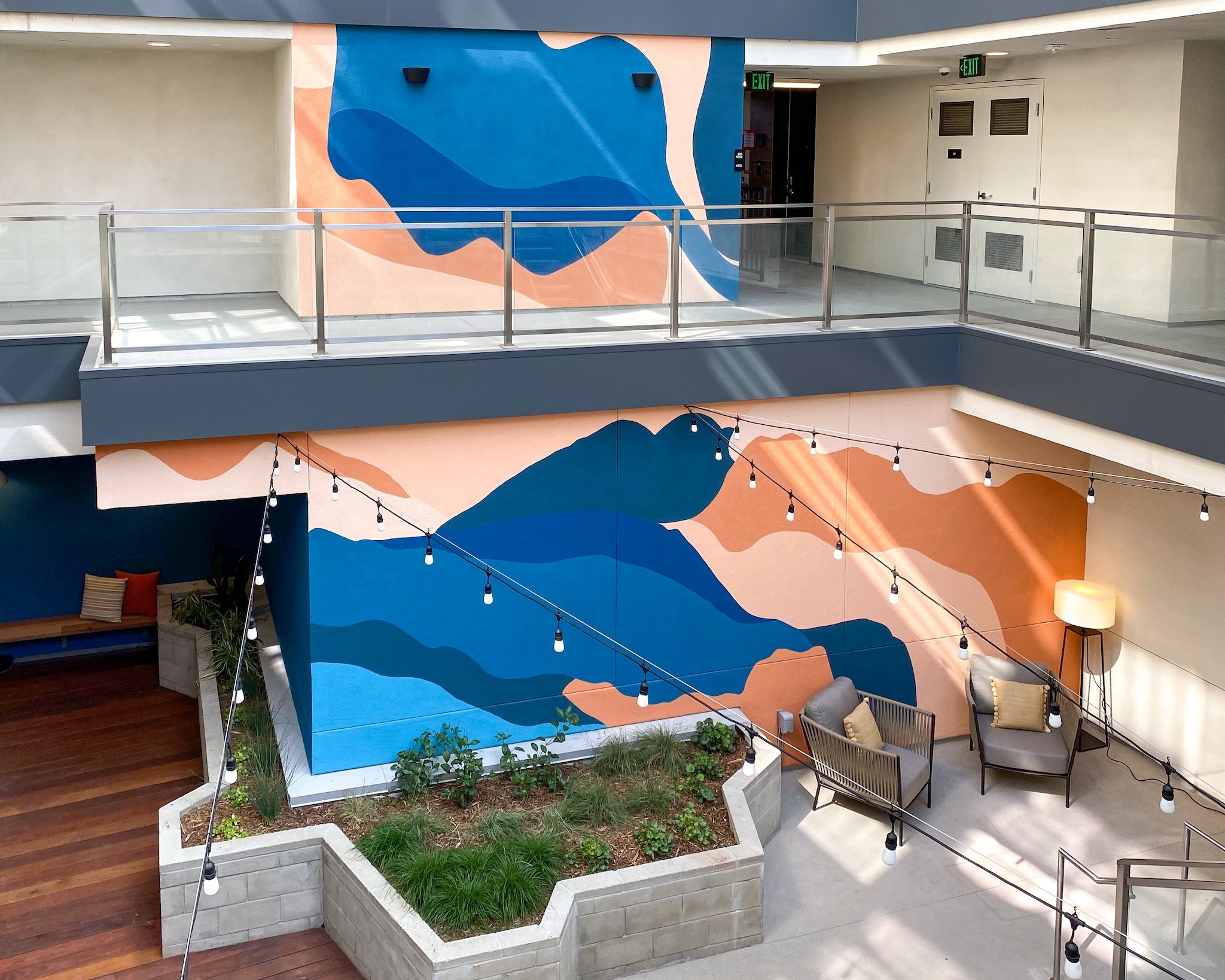 Custom hand-painted mural at 1641 Lincoln apartment complex, designed by WRAPPED Studio for a residential courtyard.