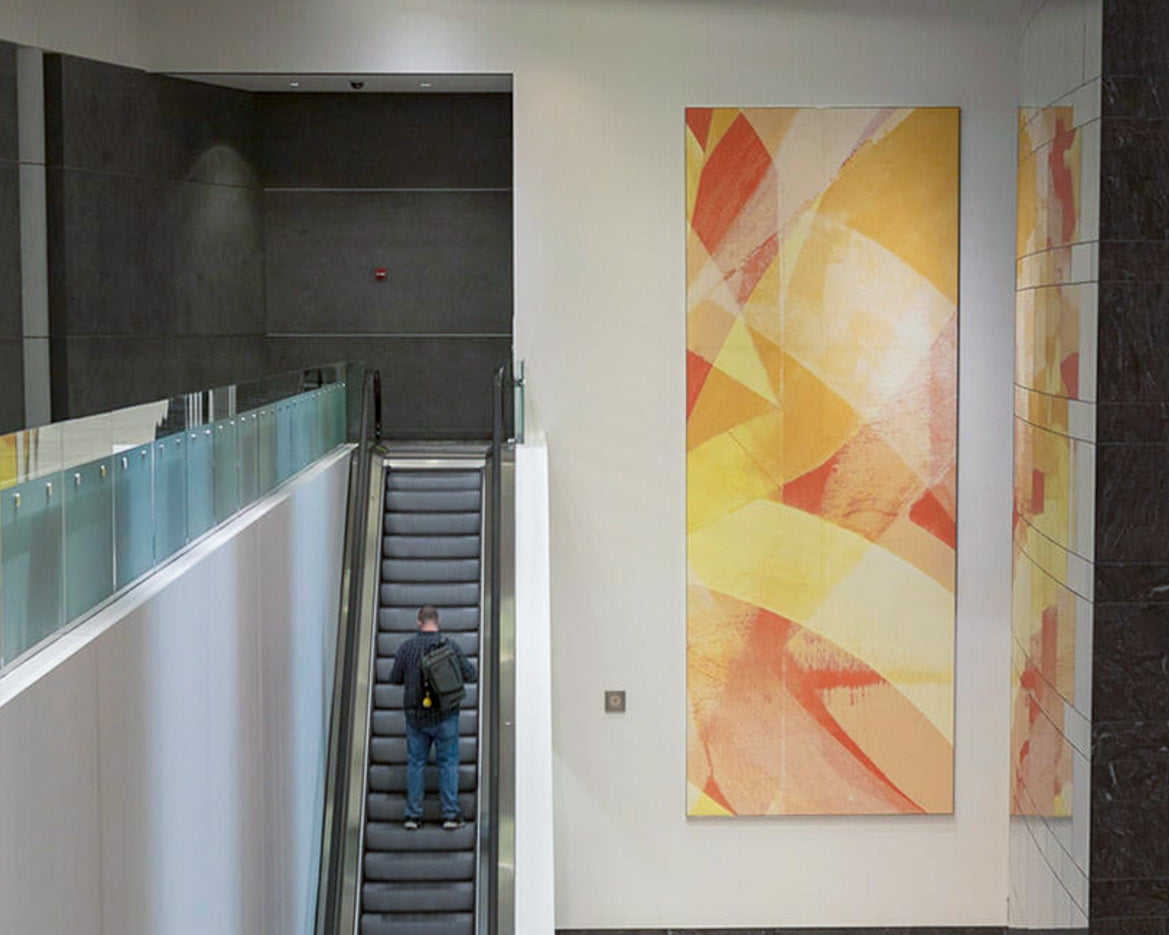 Interior of 71 South Wacker Drive lobby featuring a large-scale abstract canvas with dynamic yellow and red strokes by WRAPPED Studio, highlighting the building's modern aesthetic.