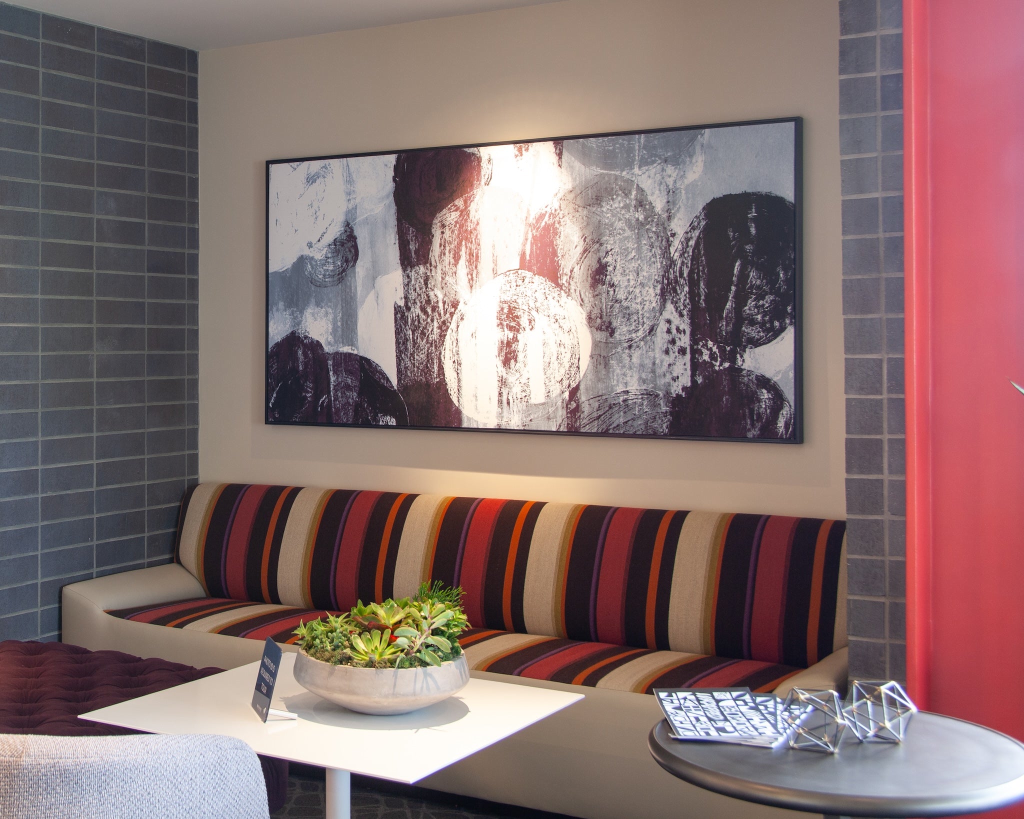 Custom abstract artwork by WRAPPED Studio installed in a resident lounge at Alexan Aspect, a multifamily development.