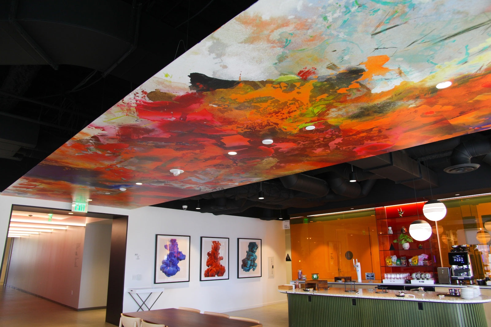 Brightly colored abstract wallcovering on the ceiling located at Convene HQ