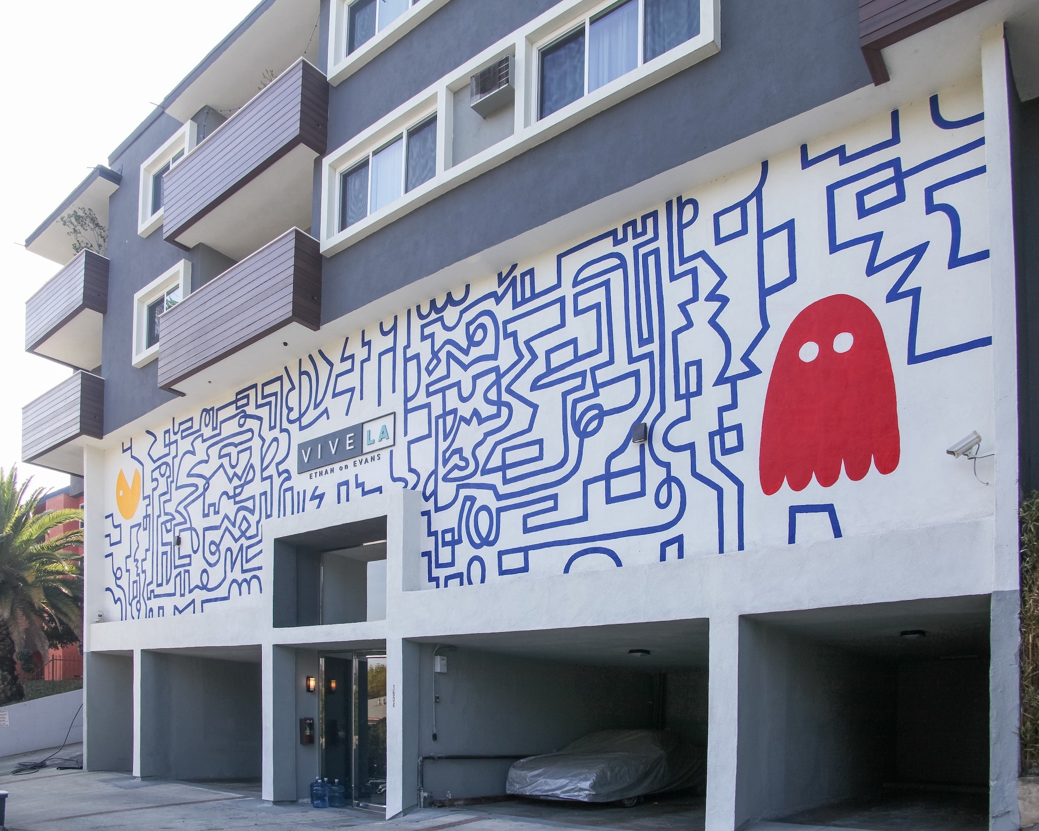 Hand-painted mural by WRAPPED Studio on the exterior of Ethan on Evans, a multifamily apartment property in Los Angeles.