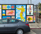 Part of the Venice mural by WRAPPED Studio, paying tribute to Muscle Beach with a stylized bodybuilder, embedded within a larger narrative tapestry of the local culture.